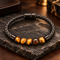 SAAN Armband mit goldbraunen Tigerauge-Perlen, natürlicher Maserung und schwarzem geflochtenem Band.